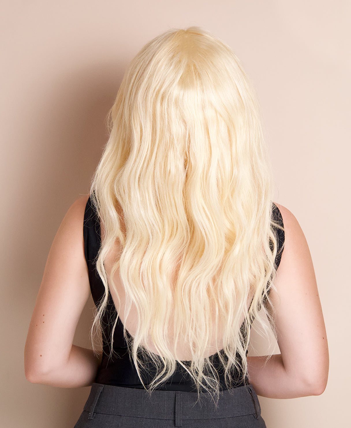 model wearing a blonde human hair wig